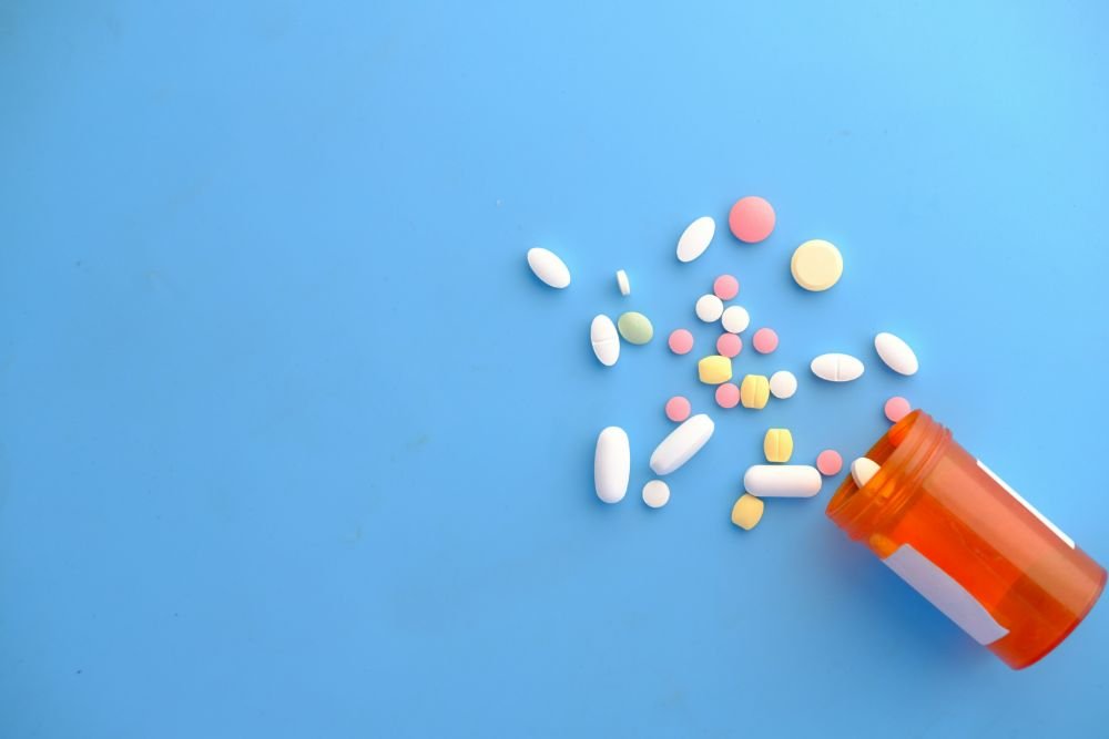 Tablets beside a dispensing bottle