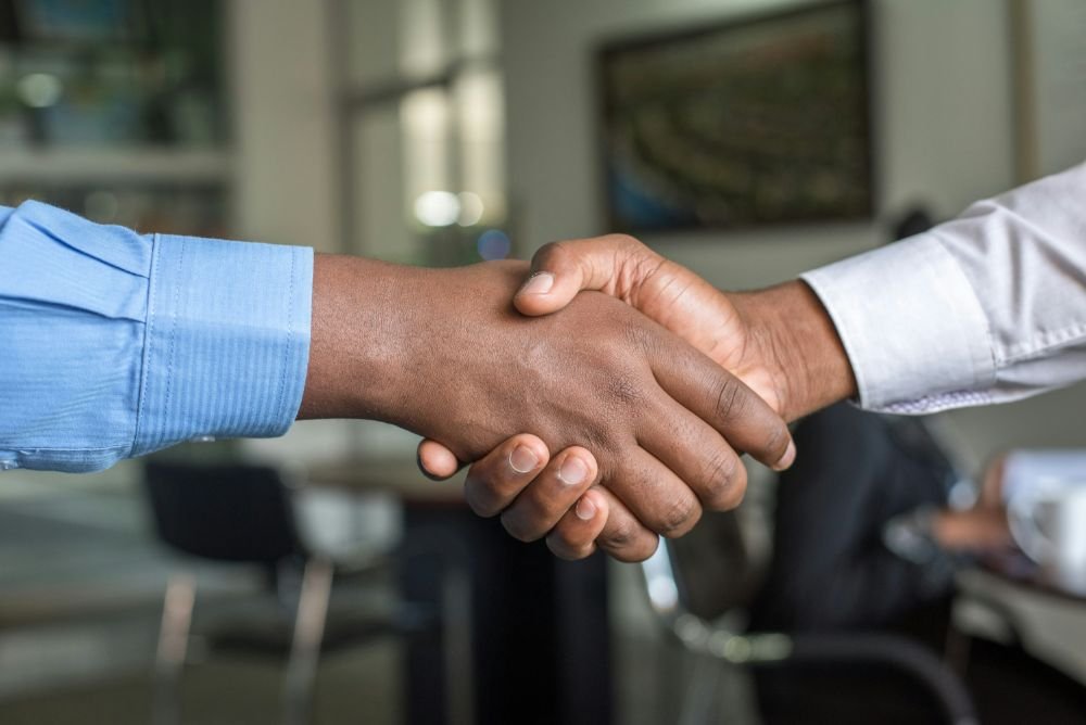 Two people shaking hands after agreeing a supply arrangement